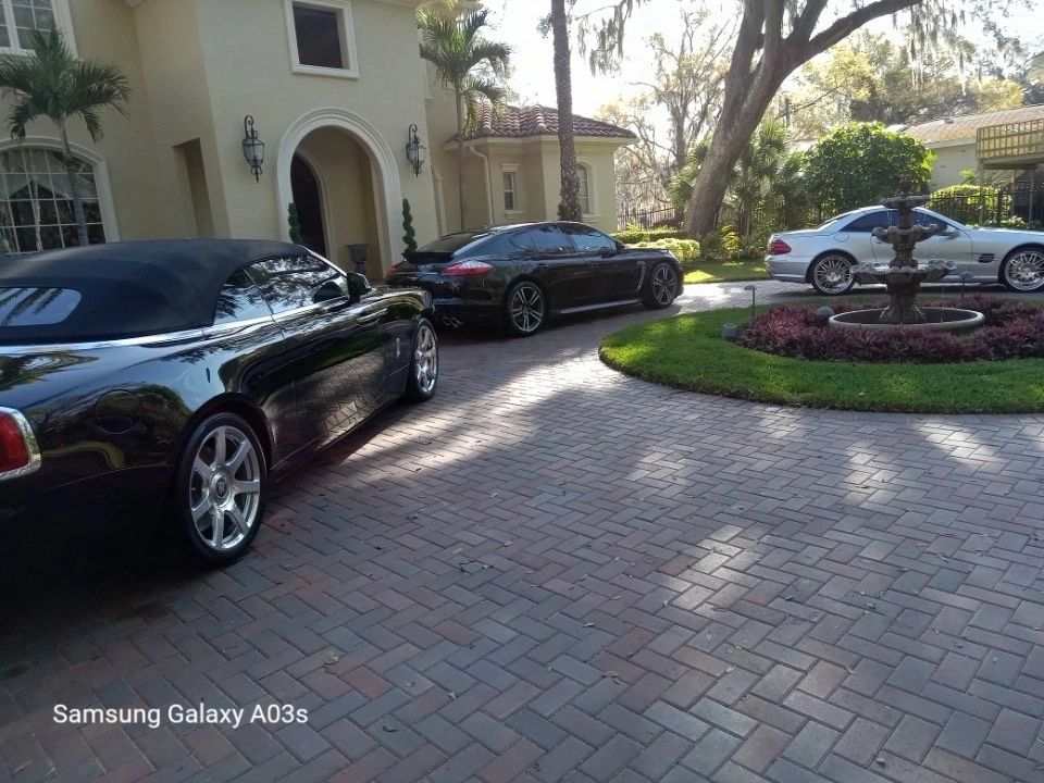 Detailed luxury cars lined up in a driveway after a mobile detailing visit