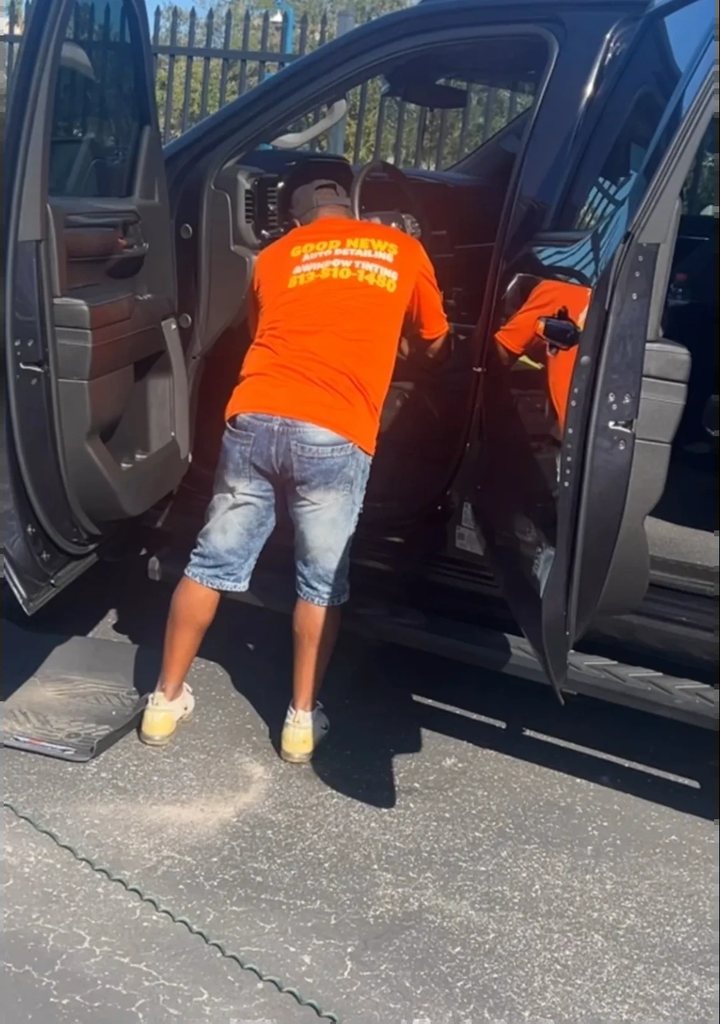 Our crew in branded orange shirts detailing a truck interior in Tampa