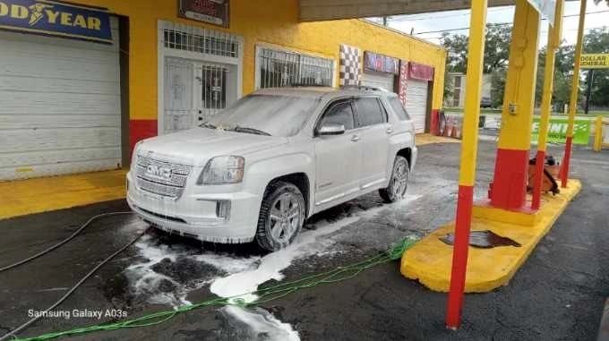 White truck being hand washed during a detailing service